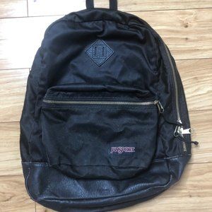 Black Jansport with golden zippers